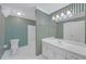 Stylish bathroom with vintage wallpaper, toilet, and vanity with framed mirror at 1405 Wilmington Way, Grayson, GA 30017