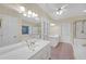 Bathroom showcasing double vanities, tiled floors, a shower, and a soaking tub at 1405 Wilmington Way, Grayson, GA 30017