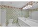 Bathroom with floral wallpaper, shower and tub combo, and vanity with marble countertop at 1405 Wilmington Way, Grayson, GA 30017