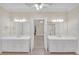 Bathroom featuring double vanities, tiled floors, and an entrance to the Primary bedroom at 1405 Wilmington Way, Grayson, GA 30017