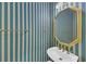 Stylish bathroom featuring striped wallpaper, gold fixtures, and a modern sink at 1405 Wilmington Way, Grayson, GA 30017