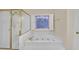 Bathroom features a soaking tub with jets, a stained glass window, and a glass shower at 1405 Wilmington Way, Grayson, GA 30017