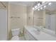 Bathroom featuring neutral walls with vintage wallpaper, vanity with mirror, and tub with shower at 1405 Wilmington Way, Grayson, GA 30017