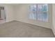 Bedroom featuring neutral walls and carpet with a large window and white trim at 1405 Wilmington Way, Grayson, GA 30017