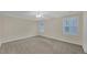 Spacious bedroom with neutral walls and trim with natural lighting from large windows at 1405 Wilmington Way, Grayson, GA 30017