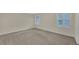 Neutral bedroom filled with light from two windows and featuring neutral carpeting at 1405 Wilmington Way, Grayson, GA 30017