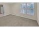 Bedroom features a carpeted floor and a window with white plantation shutters at 1405 Wilmington Way, Grayson, GA 30017