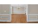 Formal dining room with hardwood floors, wainscoting, and a stylish chandelier at 1405 Wilmington Way, Grayson, GA 30017