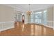Bright dining room with large windows, hardwood floors, and an elegant chandelier for a luxurious touch at 1405 Wilmington Way, Grayson, GA 30017