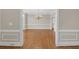 Spacious dining room with hardwood floors, chandelier, and elegant wainscoting at 1405 Wilmington Way, Grayson, GA 30017