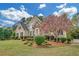Charming home with a well-maintained lawn and a flowering tree, complementing the house's architectural style at 1405 Wilmington Way, Grayson, GA 30017