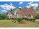 Charming two-story home with lush landscaping, decorative stone, and a blooming tree at 1405 Wilmington Way, Grayson, GA 30017
