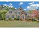 Stunning two-story home featuring a manicured front lawn and a combination of stone and stucco facade at 1405 Wilmington Way, Grayson, GA 30017