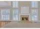 Close-up of the fireplace with a gold inlay and surrounded by bright windows at 1405 Wilmington Way, Grayson, GA 30017