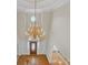 Foyer showcasing hardwood floors, a wooden front door, and a chandelier at 1405 Wilmington Way, Grayson, GA 30017