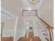 Elegant foyer featuring a staircase, chandelier, and an open view of the living room at 1405 Wilmington Way, Grayson, GA 30017