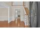 Bright foyer with hardwood floors, staircase, and views into the living spaces at 1405 Wilmington Way, Grayson, GA 30017