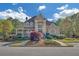 Elegant home featuring a covered porch, manicured landscaping, and a grand entrance with tall columns and large windows at 1405 Wilmington Way, Grayson, GA 30017