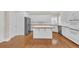Bright kitchen featuring white cabinets, an island, and modern appliances at 1405 Wilmington Way, Grayson, GA 30017