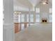 Spacious living room featuring hardwood floors, a fireplace, and large windows for ample natural light at 1405 Wilmington Way, Grayson, GA 30017
