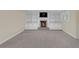 Finished basement features a fireplace, shelving, cabinets, and neutral walls and carpet at 1405 Wilmington Way, Grayson, GA 30017