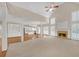 This open-concept living room features a fireplace and connects to a kitchen, creating a perfect space for entertaining at 1405 Wilmington Way, Grayson, GA 30017