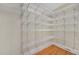 Bright walk-in closet featuring wire shelves and light hardwood floors at 1405 Wilmington Way, Grayson, GA 30017
