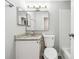 Bathroom featuring a granite vanity top, large mirror, and a white tiled tub at 1501 Clairmont Rd # 1624, Decatur, GA 30033