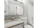 Bathroom featuring granite vanity top, large mirror, and white tiled tub and shower at 1501 Clairmont Rd # 1624, Decatur, GA 30033