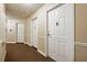 Hallway with neutral paint and carpeting leading to apartments with white doors at 1501 Clairmont Rd # 1624, Decatur, GA 30033