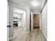 Hallway with gray wood floors connects the entryway to the kitchen and other areas of the home at 1501 Clairmont Rd # 1624, Decatur, GA 30033