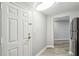 Hallway that leads into the kitchen and living area with gray wood flooring and neutral gray walls at 1501 Clairmont Rd # 1624, Decatur, GA 30033