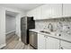 Kitchen boasts stainless steel appliances and sleek countertops with grey backsplash tiles at 1501 Clairmont Rd # 1624, Decatur, GA 30033