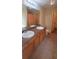 Bathroom features a double vanity with storage and a large mirror; tiled floors throughout at 237 Summergate Ln, Villa Rica, GA 30180