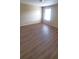 Well-lit bedroom featuring hard wood floors and a large window for natural light at 237 Summergate Ln, Villa Rica, GA 30180