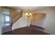 Dining area with modern chandelier, staircase and archway to other living spaces at 237 Summergate Ln, Villa Rica, GA 30180