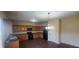 An eat-in kitchen with wooden cabinets, dark countertops and modern black appliances at 237 Summergate Ln, Villa Rica, GA 30180