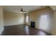 Cozy living room featuring a fireplace, ceiling fan, and a patio door at 237 Summergate Ln, Villa Rica, GA 30180