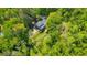 Aerial view of a secluded home surrounded by lush green trees and a large backyard at 2940 Blue Sky Pl, Marietta, GA 30068