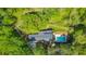 Aerial view of the home nestled in a wooded area with a private pool and stream in the backyard at 2940 Blue Sky Pl, Marietta, GA 30068