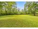 Expansive green backyard view with mature trees providing ample shade and privacy at 2940 Blue Sky Pl, Marietta, GA 30068