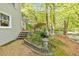 Landscaped backyard featuring native plantings, trees, creek and unique garden art at 2940 Blue Sky Pl, Marietta, GA 30068