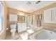 This is a pristine bathroom featuring a toilet, vanity, walk-in shower, and a large soaking tub at 2940 Blue Sky Pl, Marietta, GA 30068