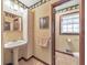 Bathroom featuring pedestal sink, tiled floors, and floral wallpaper at 2940 Blue Sky Pl, Marietta, GA 30068
