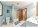 This traditional bathroom has a toilet, shower, vanity and mirror, and a large window for natural light at 2940 Blue Sky Pl, Marietta, GA 30068
