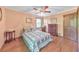 The bedroom includes a bed with a quilt, a side table, dresser, and hardwood floors at 2940 Blue Sky Pl, Marietta, GA 30068
