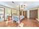 This is a cozy main bedroom with hard wood floors and a door leading to the attached bathroom at 2940 Blue Sky Pl, Marietta, GA 30068