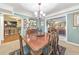 Charming dining room with classic wood table and view to kitchen and living room at 2940 Blue Sky Pl, Marietta, GA 30068