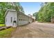 Wide driveway leading to a three-car garage, surrounded by lush greenery at 2940 Blue Sky Pl, Marietta, GA 30068
