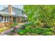 Charming home featuring a brick facade, lush gardens, and inviting outdoor seating at 2940 Blue Sky Pl, Marietta, GA 30068